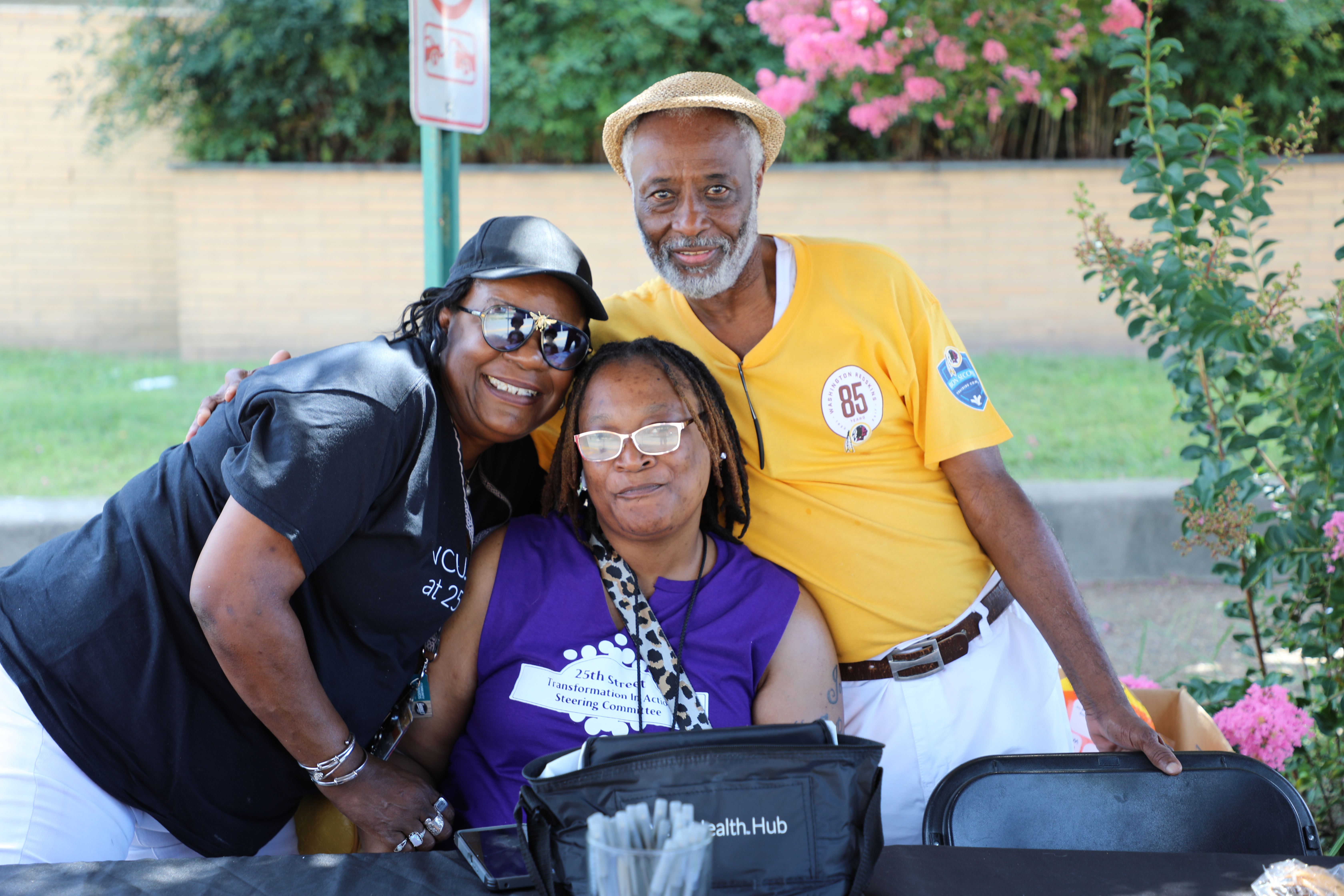 group of three people taking a photo
