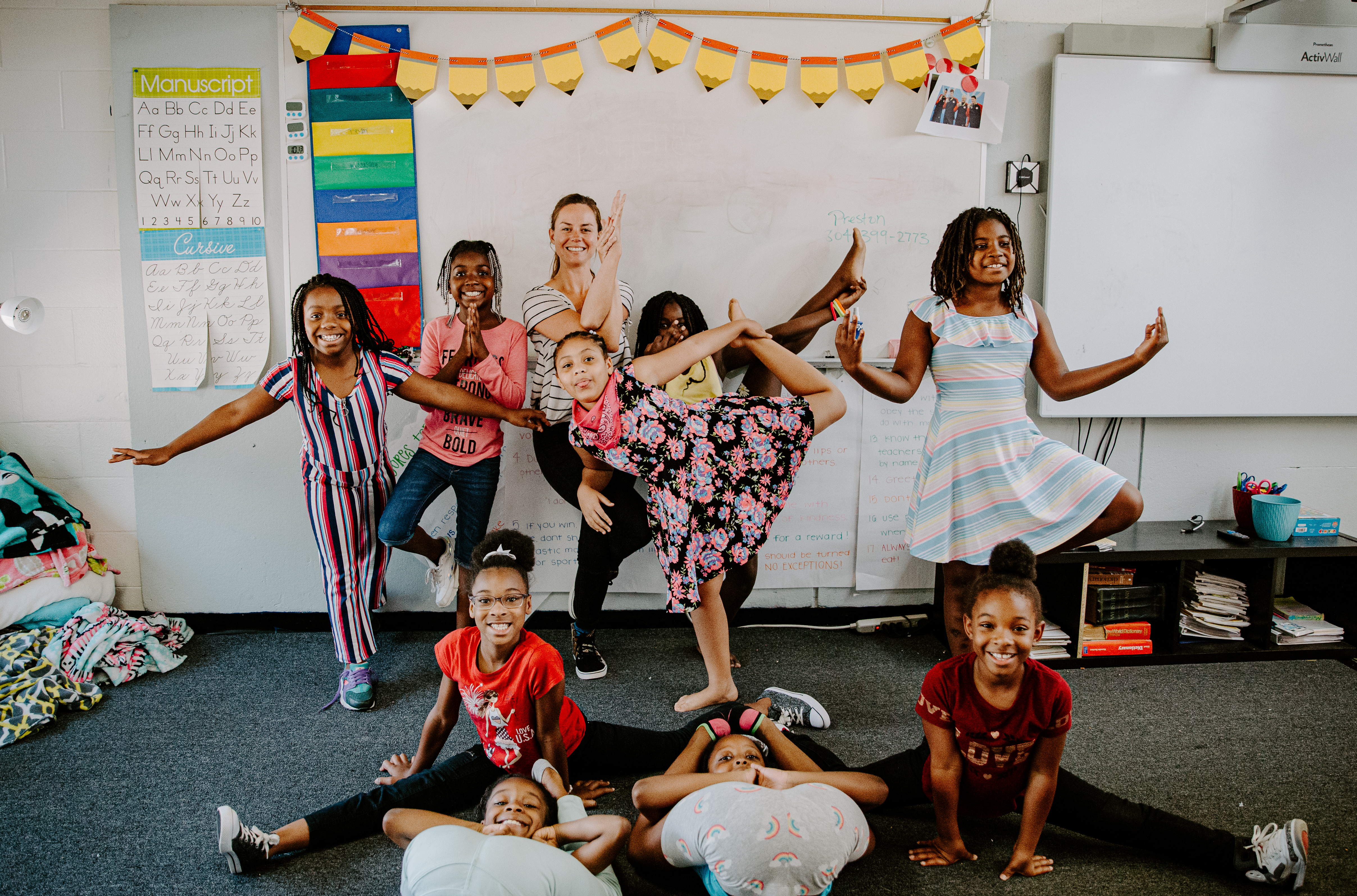 A group of youth posing in yoga positions